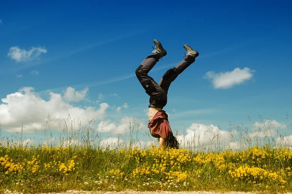 Wanita muda melakukan cartwheel di padang rumput — Stok Foto