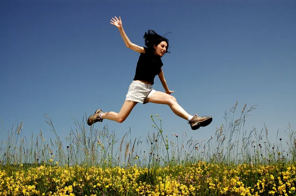 Beautiful young woman jumping — Stock Photo, Image