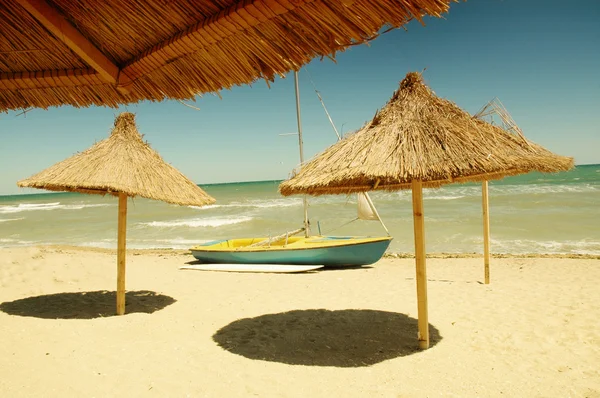 stock image Beach umbrella and a boat