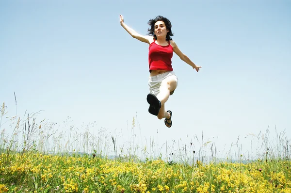 Beautiful young woman jumping — Stock Photo, Image