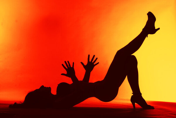 Sexy woman silhouette on red background
