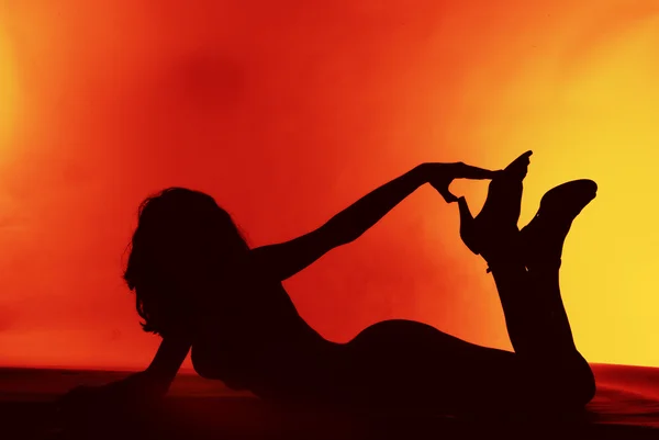 Sexy girl silhouette on a red background — Stock Photo, Image