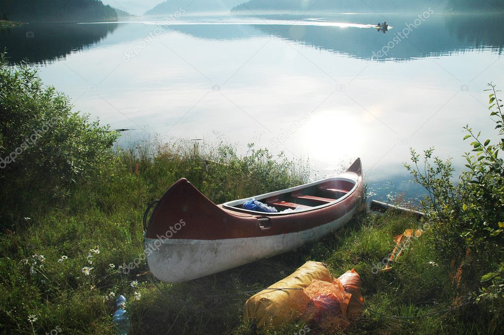 Canoe near the lake in morning lights