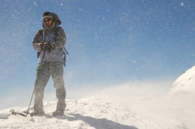 The summit of mountain with a mountaineer on the top. Retezat peak clipart