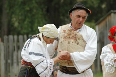 A group of dancers in traditional clothes in Romania clipart