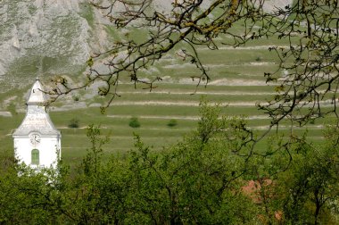 Hungarian church in a mountainous region in Transylvania clipart