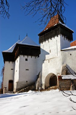 Snow covered fortified church of Viscri, Transylvania clipart