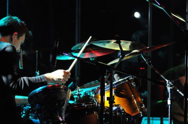 Drummer performing live clipart