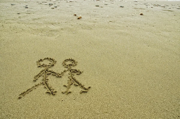 Einfaches Paar zeichnet im Sand am Strand — Stockfoto