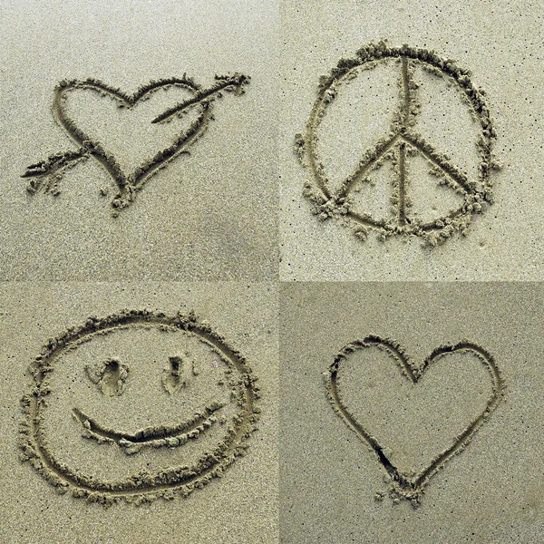 Diferentes sinais desenhados na areia — Fotografia de Stock