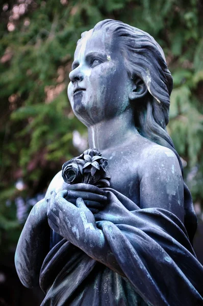 Mladá dívka socha drží kytici květin, salzburg cemeter — Stock fotografie