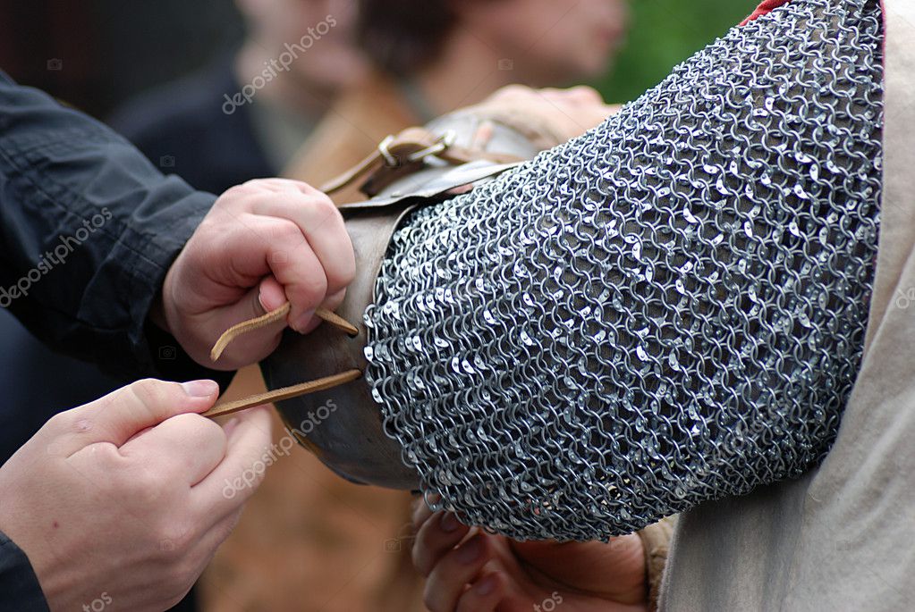 Hands tying ropes on metallic armor — Stock Photo © Nevakalina 9148984