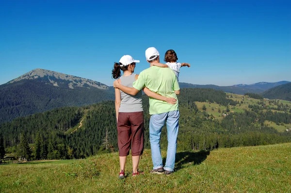 Active family of three on their vacation in mountains — Stock Photo, Image