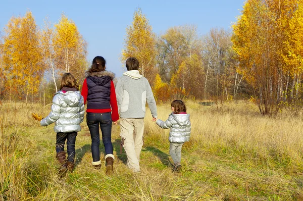 Happy active family in autumn park — Stock Photo, Image