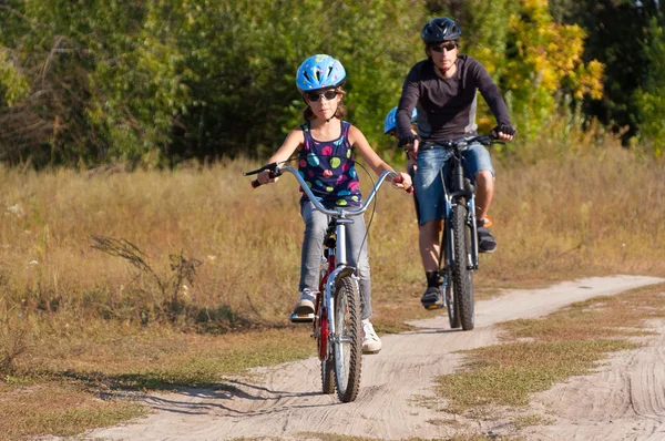 Active family cycling outdoors — Stock Photo, Image