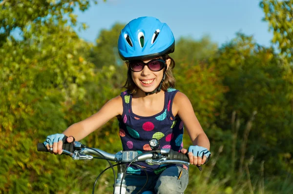 Happy girl cycling outdoors — Stock Photo, Image