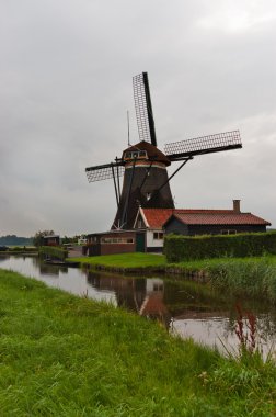 Beautiful Dutch windmill and canal, Holland clipart