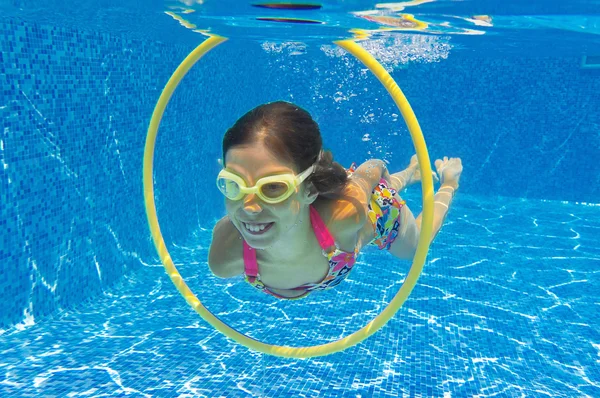 stock image Happy child swims underwater in swimming pool