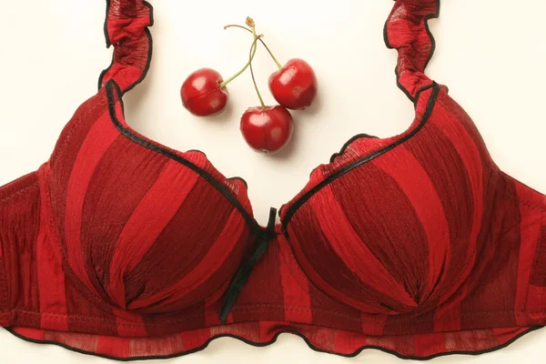 Red bra and cherries — Stock Photo, Image