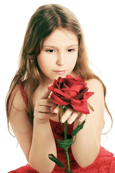 Gyönyörű gyermek lány vörös rózsa. — Stock Fotó