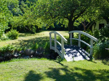 Small wooden bridge in a garden clipart