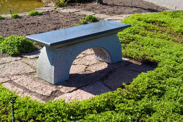 Beautiful Japanese garden stone granite seating bench — Stock Photo, Image