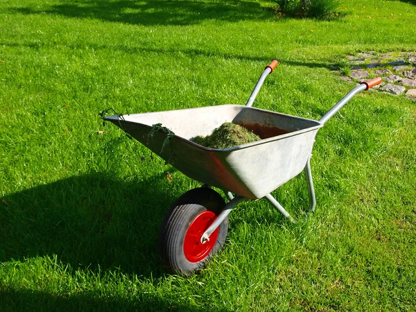 Wheelbarrow in the garden — Stock Photo, Image