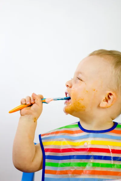 Cute Messy Infant Eating Side On — Stock Photo, Image
