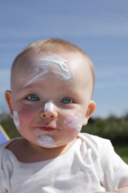 Baby in blotchy suncream clipart