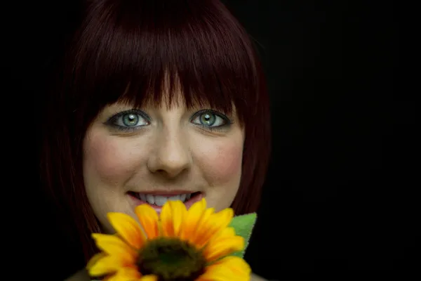 Girl Smiling Behind Sunflower — Stock Photo, Image