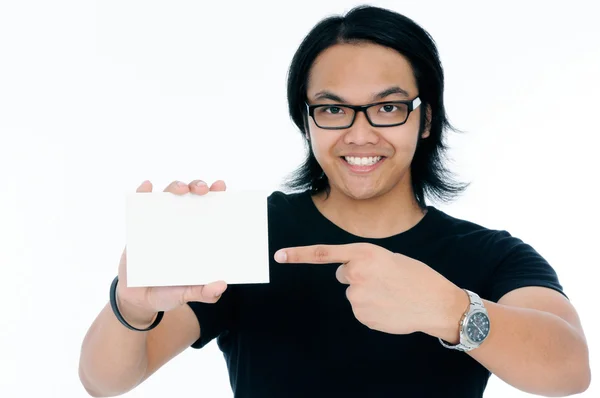 Cute Young Man Pointing At Blank Card — Stock Photo, Image