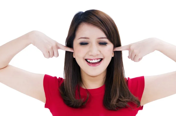 Happy young woman poking fingers into her ears — Stock Photo, Image