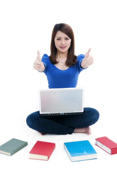 Pretty student giving thumbs up sign — Stock Photo, Image