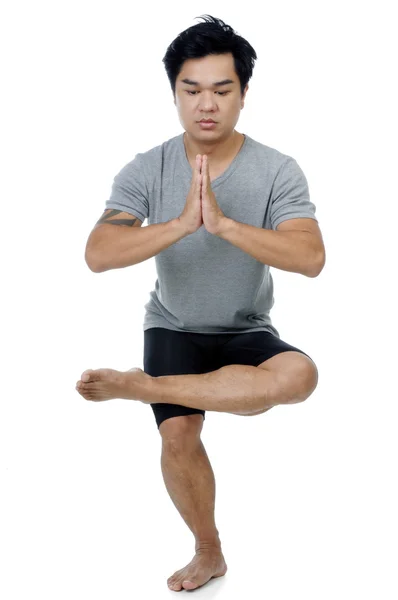 Jonge man in yoga pose Rechtenvrije Stockfoto's