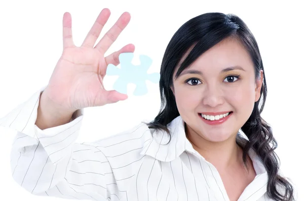 Happy young businesswoman holding jigsaw puzzle — Stock Photo, Image