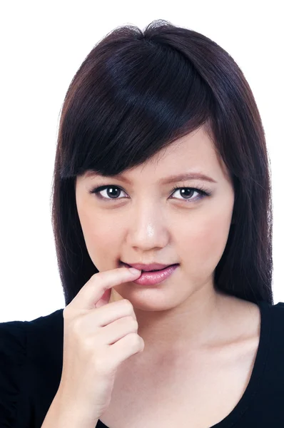 Roztomilé mladé asijské ženy kousání prst — Stock fotografie