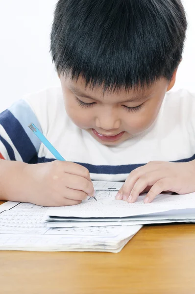 Schoolboy doing his school work — Stock Photo, Image