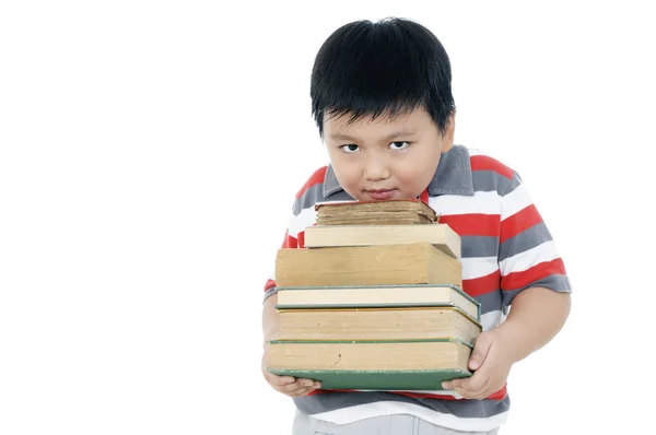 Elementära skolpojke bär böcker Stockbild