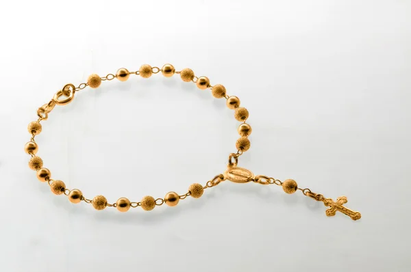 Gold rosary with cross — Stock Photo, Image