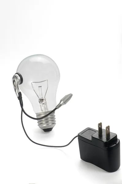 Bulb and power plug headphones on white background — Stock Photo, Image