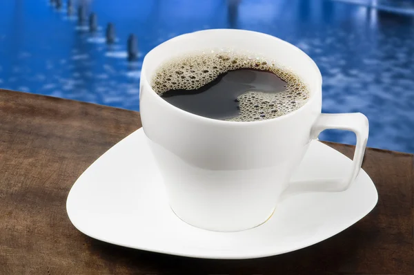 Weiße Kaffeetasse mit blauem Hintergrund — Stockfoto