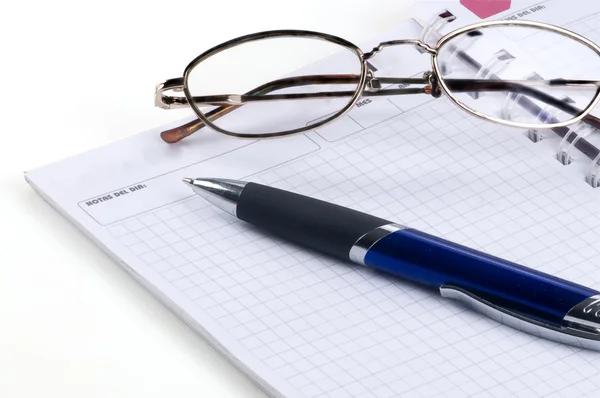 Notepad and pen glasses isolated on white background Stock Image