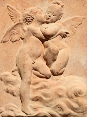 Two kissing angels relief in tuscan terracotta, Italy clipart