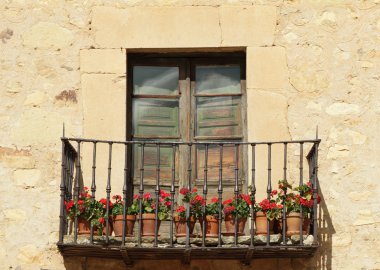 Idyllic balcony with red flowers clipart