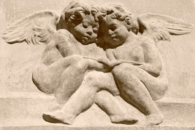 Vintage image of two angels carved in clay clipart