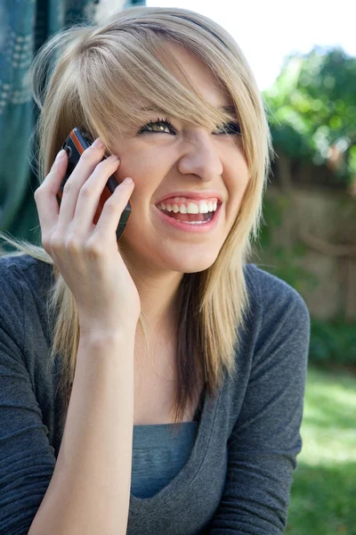 Laughing happy Teenager on Mobile Cell Phone — Stock Photo, Image