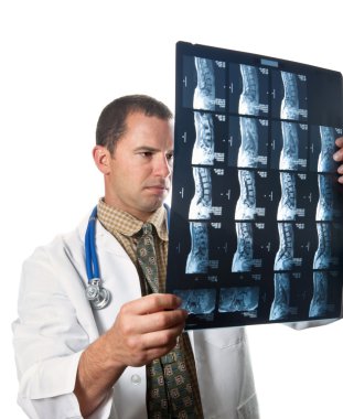 Male Doctor Examining MRI Film Scans clipart