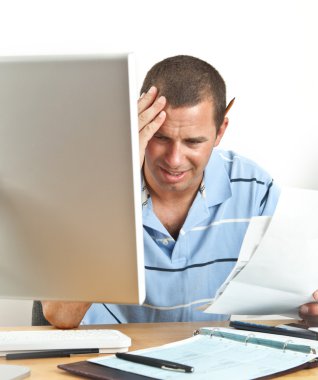 Worried Man with Headache Paying Bills clipart