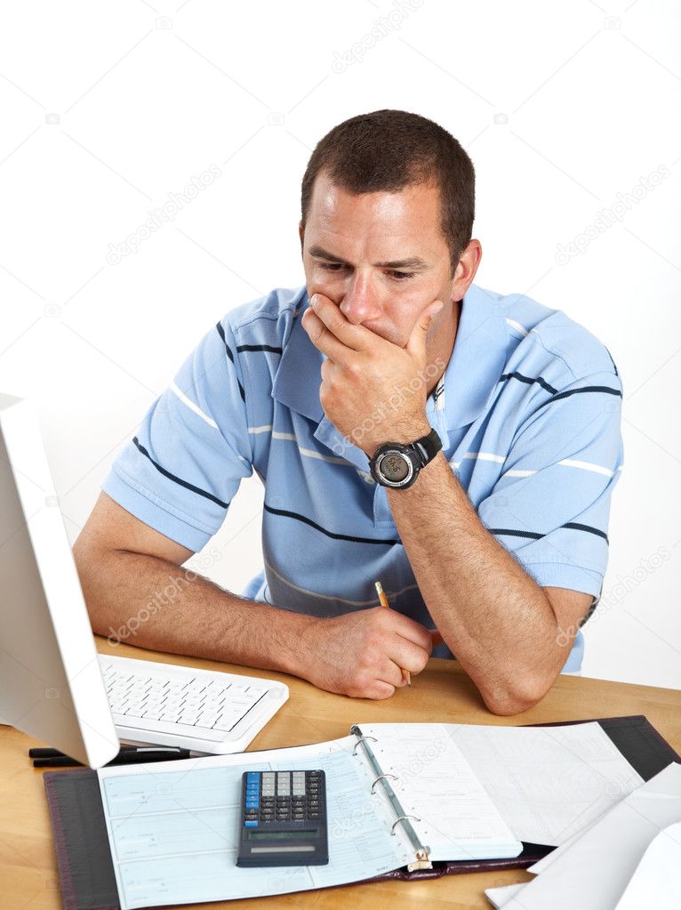 Worried young businessman at desk
