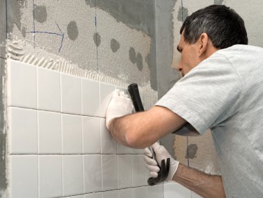 Man Tiling A Wall clipart